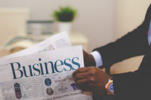 ultra high-net-worth investors concept of a man reading business section of newspaper